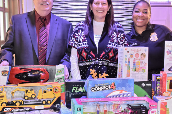 President JFKACA Dayna Harap flanked with Mark Mathers (retired CN=BP)  and CBP Officer Shakira Sanjurjo with Toys for Tots.